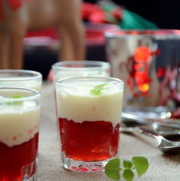 Strawberry jelly topped with vanilla semifreddo in small dessert glasses