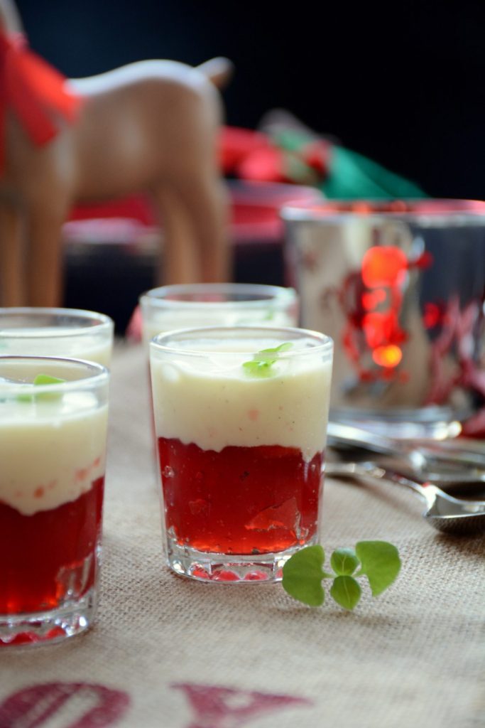 Strawberry jelly topped with vanilla semifreddo in small dessert glasses