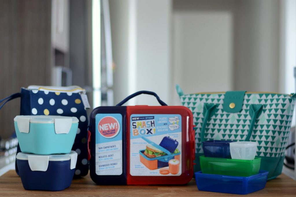 An assortment of lunch boxes and lunch bags