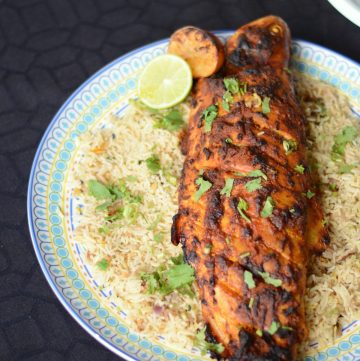 Roasted whole fish served on a bed of rice