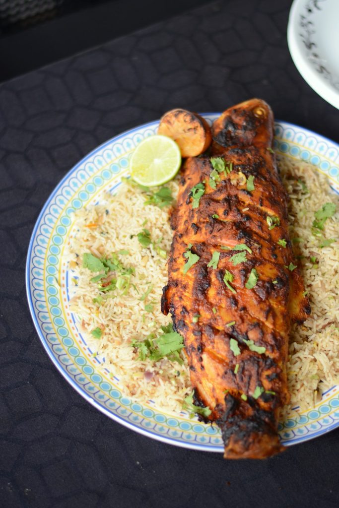 Roasted whole fish served on a bed of rice