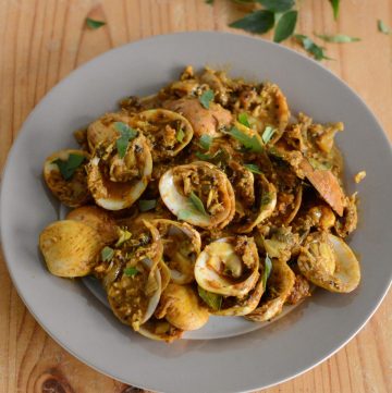 Indian style clams stir fry served on grey plate