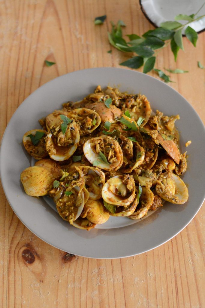 Indian style clams stir fry served on grey plate