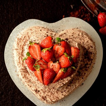 Heart shaped chocolate fudge cake with fresh strawberries on top