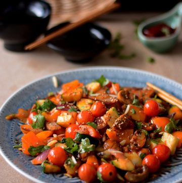 Vegetable stir fry served on blue plate