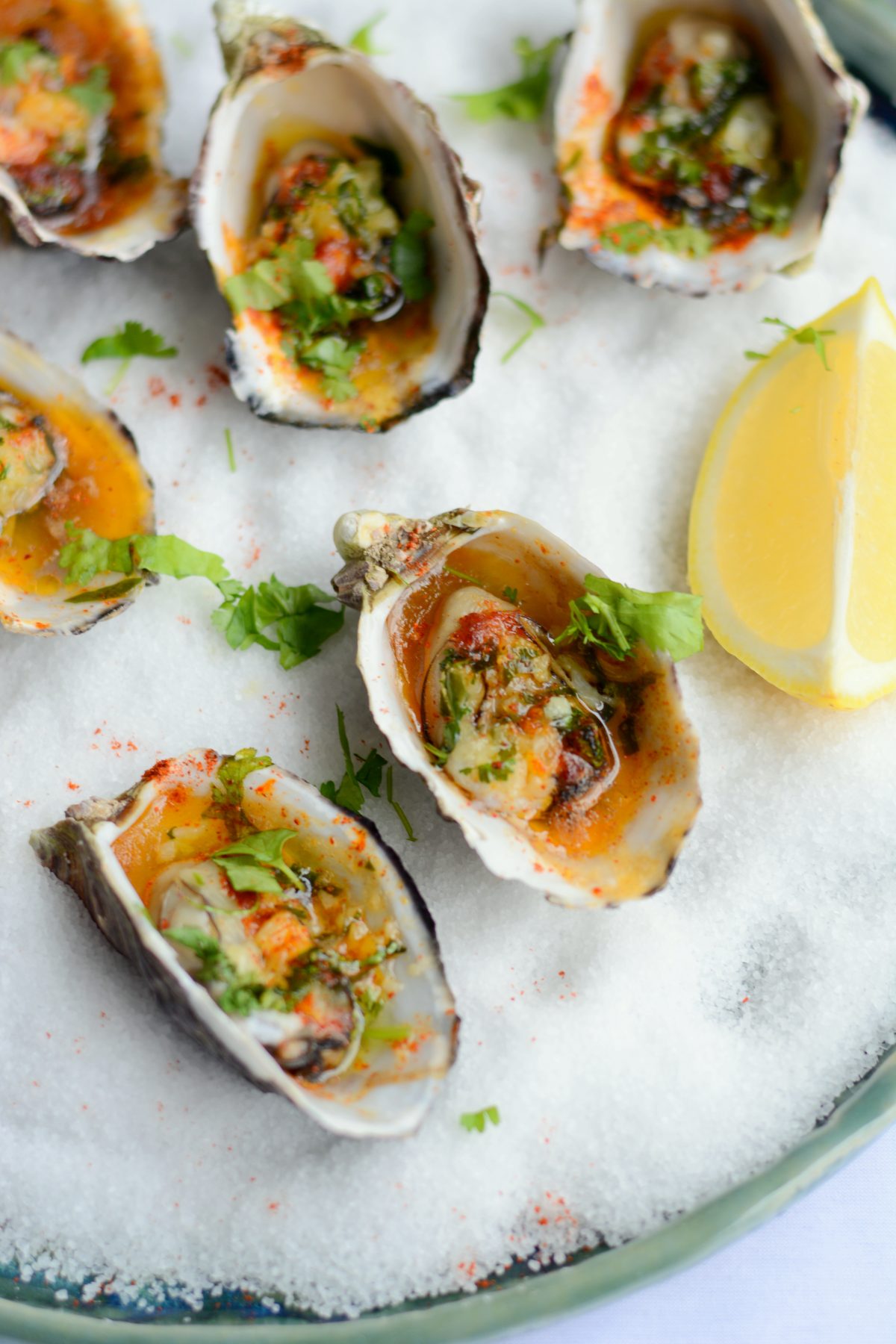 Baked Oysters with Garlic, Curry Leaf and Kashmiri Chilli - Soft, plump and juicy oysters are oven baked with a garlic and curry leaf butter emulsion, coriander leaves and Kashmiri chilli powder - thespiceadventuress.com