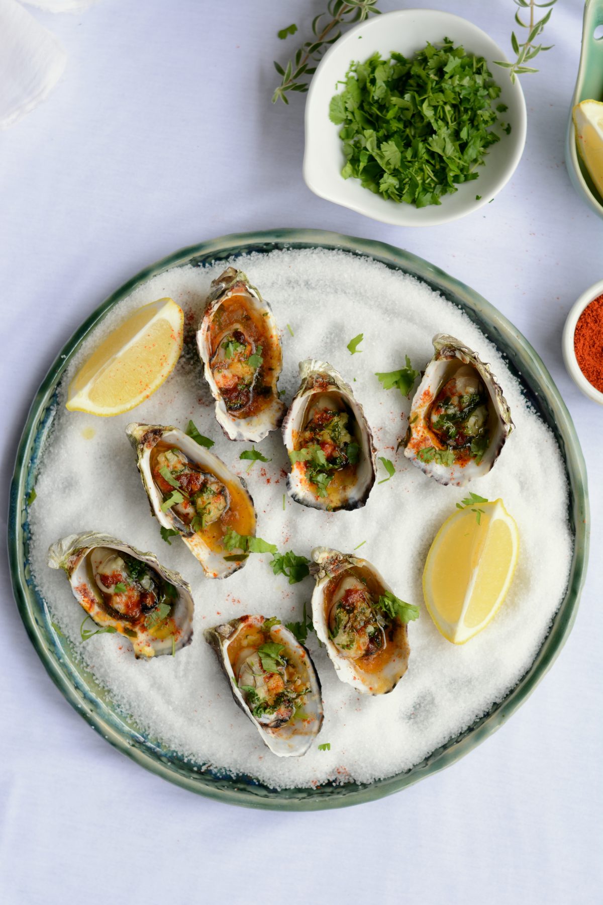 Baked Oysters with Garlic, Curry Leaf and Kashmiri Chilli - Soft, plump and juicy oysters are oven baked with a garlic and curry leaf butter emulsion, coriander leaves and Kashmiri chilli powder - thespiceadventuress.com