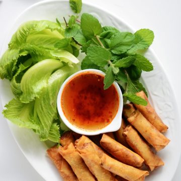 Fried prawn spring rolls served with lettuce, mint and dipping sauce