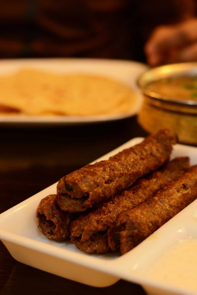 Lamb kebabs on white plate