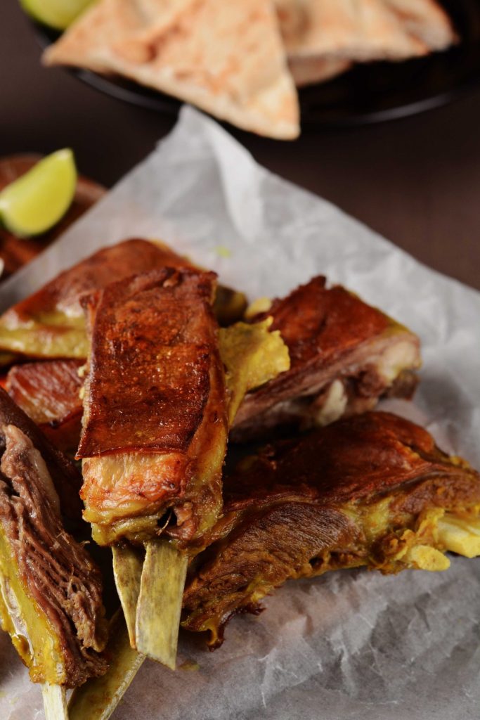 Indian style lamb ribs on white baking paper