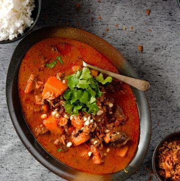 Massaman curry served in oval shaped black bowl