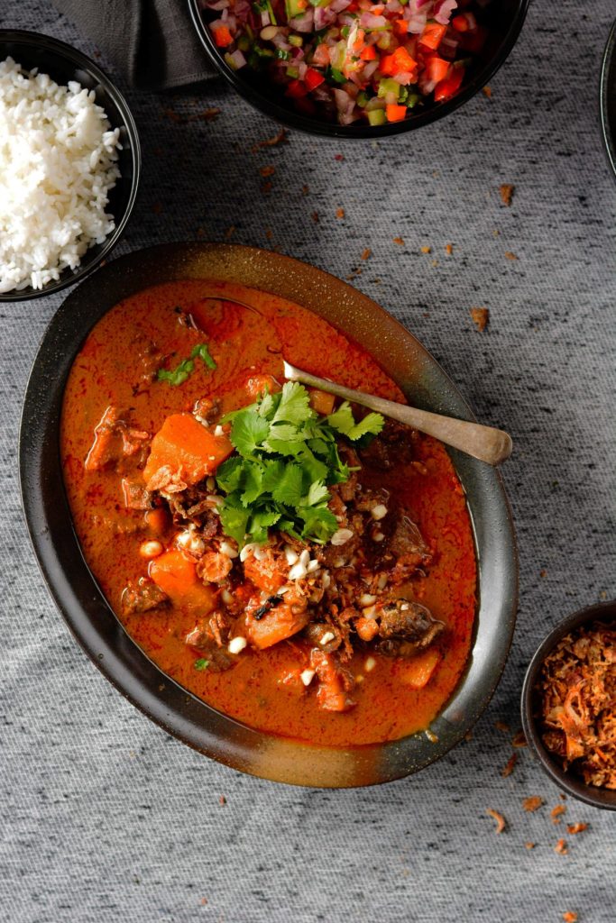 Massaman curry served in oval shaped black bowl