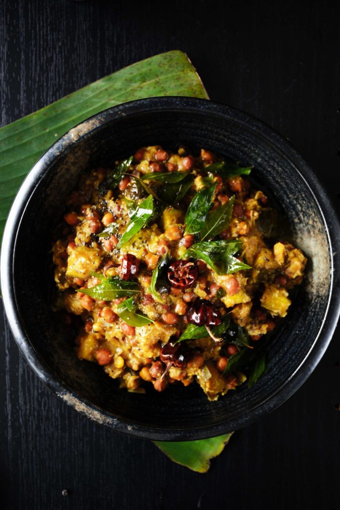 Black chickpeas, yam and plantain curry served in black bowl