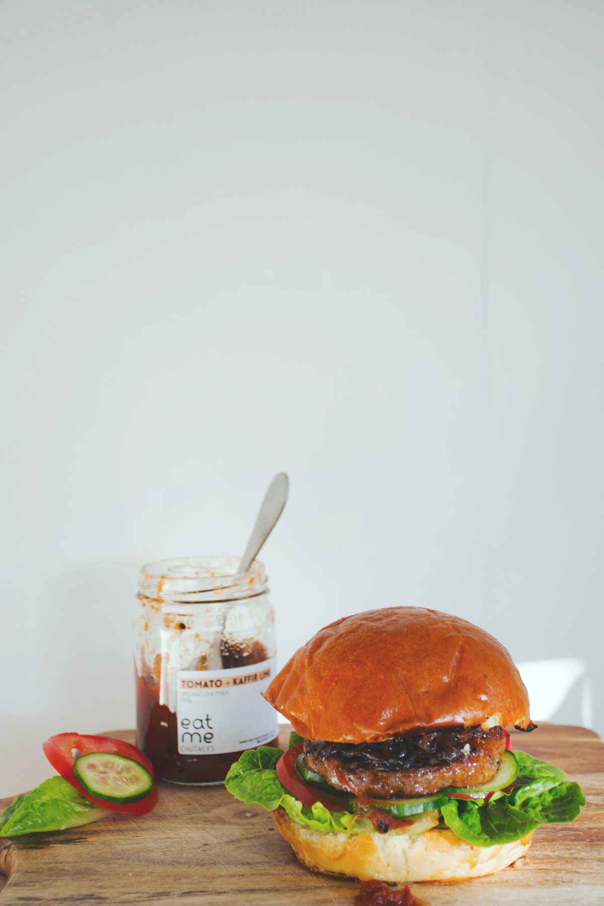 Delicious lamb burger with Tomato Kaffir Lime chutney, veggies and caramelized onions -thespiceadventuress.com