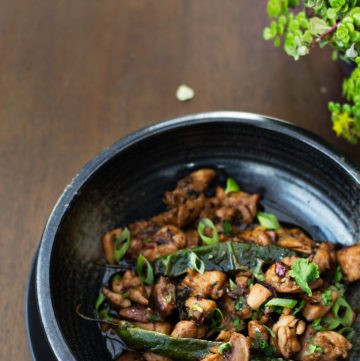 Stir fried chicken served in black bowl