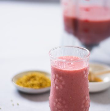 A glass of pink coloured smoothie