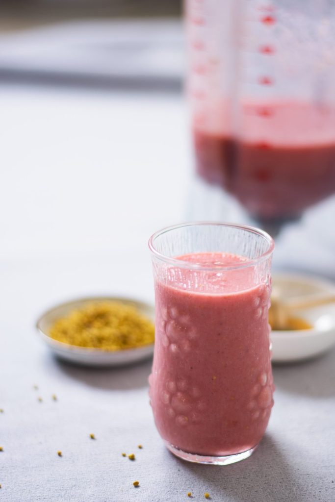 A glass of pink coloured smoothie