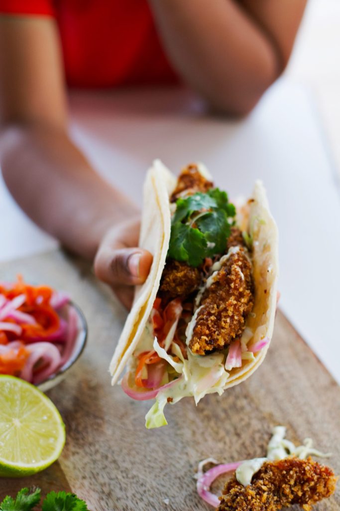 Boy holding fish tacos