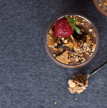 glass with chocolate dessert and fresh strawberry