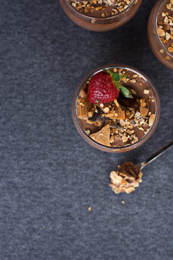 glass with chocolate dessert and fresh strawberry