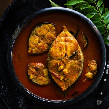 indian spanish mackerel curry in black bowl