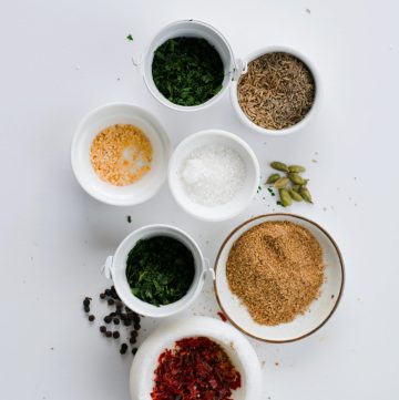 an assortment of spices in separate white bowls
