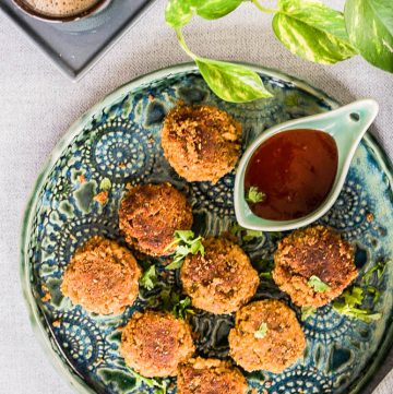 fried chickpea patties with tomato sauce on blue plate