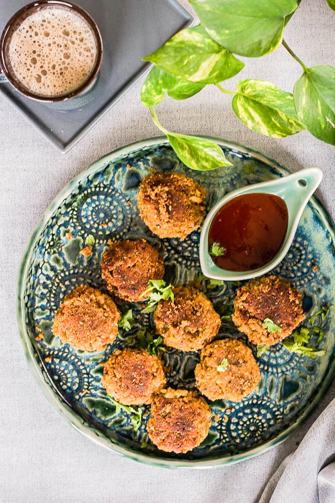 fried chickpea patties with tomato sauce on blue plate