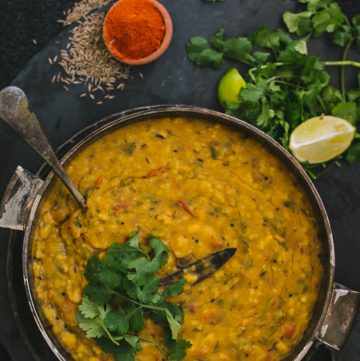 Rice with lentils in bowl and spices on the side