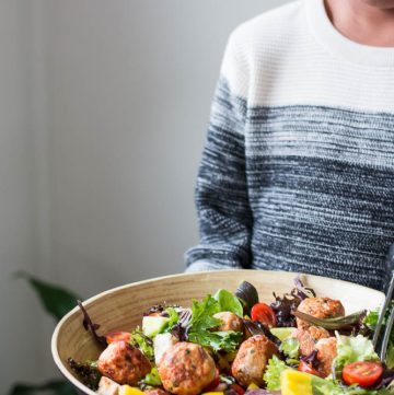 boy holding bowl with chicken meatball salad