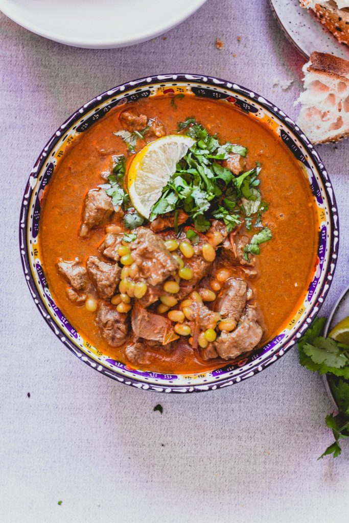 Lamb curry with haricot beans in colourful bowl