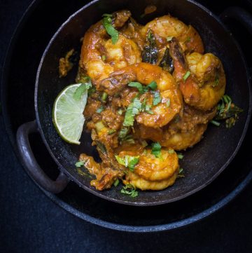 Andhra style prawns curry in black bowl