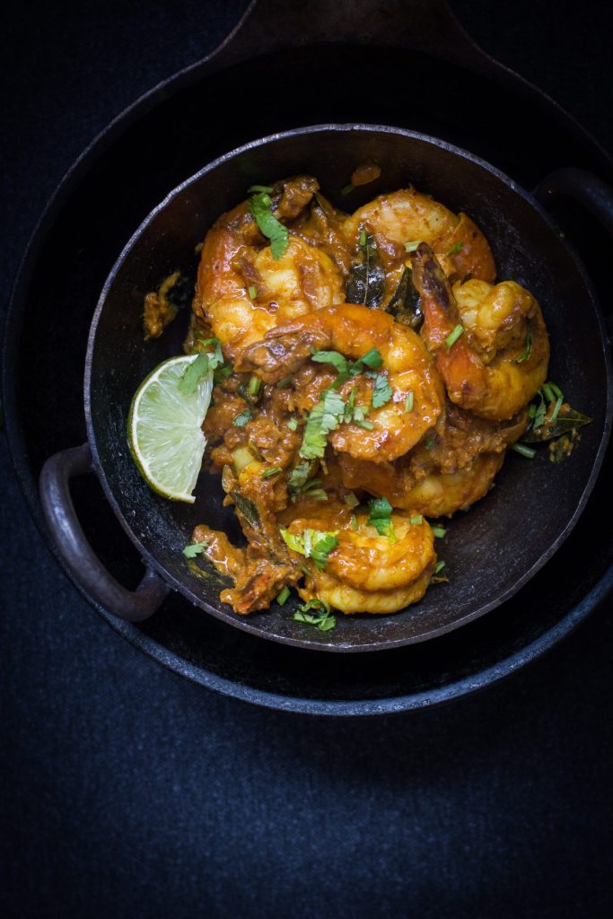 Andhra style prawns curry in black bowl