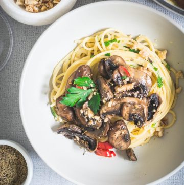 Spaghetti with mushrooms in mascarpone sauce in white plate