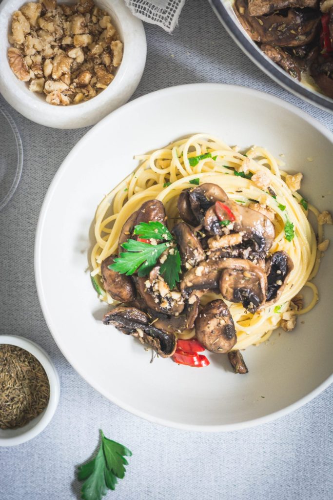 Spaghetti with mushrooms in mascarpone sauce in white plate