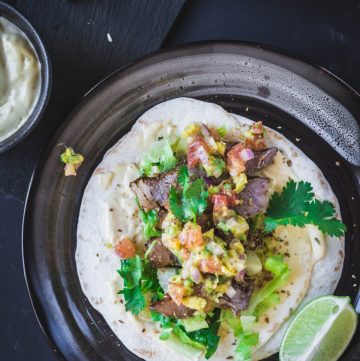 beef steak taco on black plate