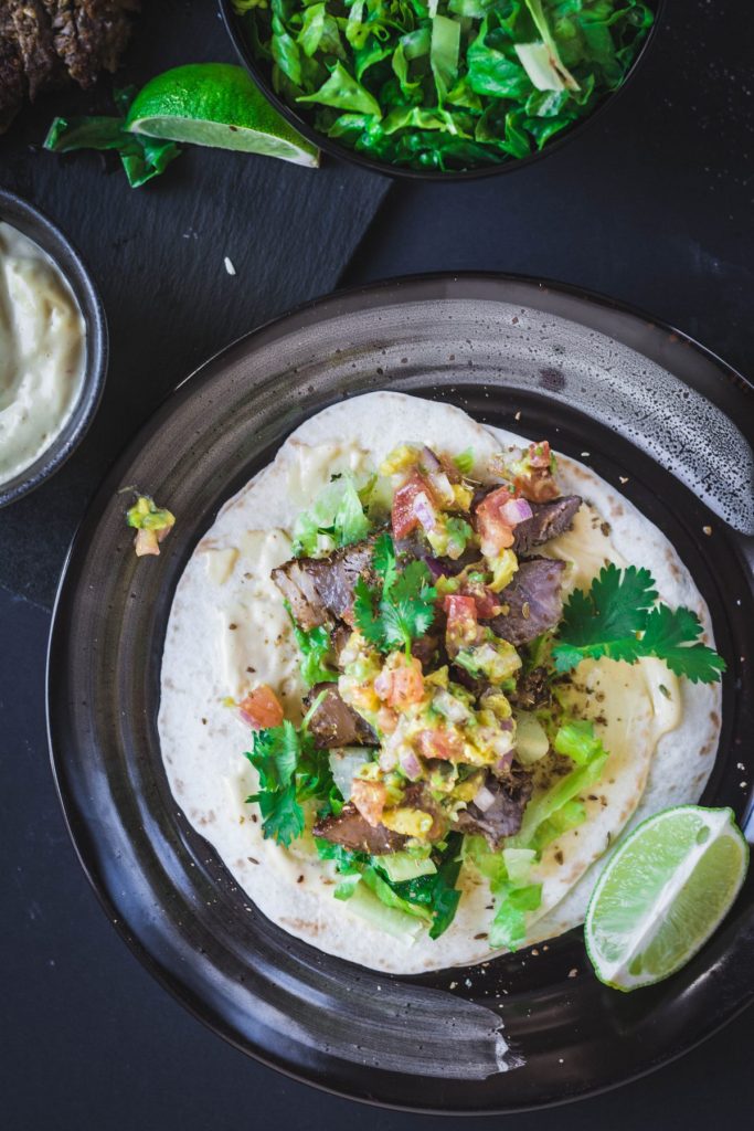 beef steak taco on black plate