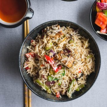 Indo Chinese style fish fried rice in black bowl