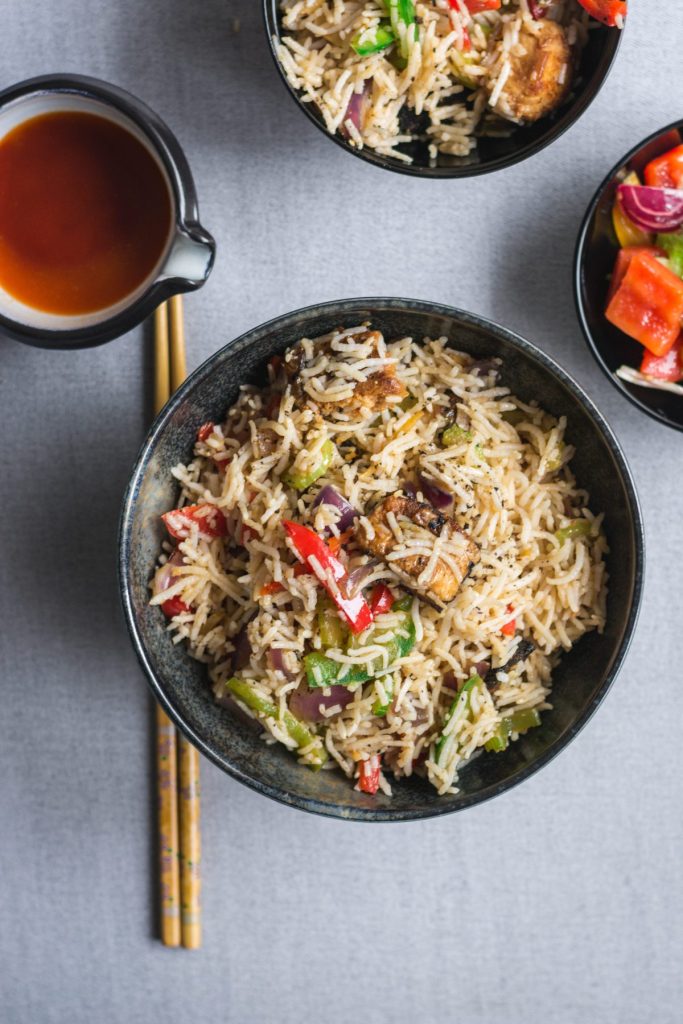 Indo Chinese style fish fried rice in black bowl