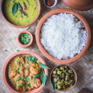 a selection of different Indian dishes in earthenware pots