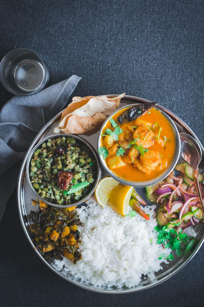 Indian food platter with rice and different curries