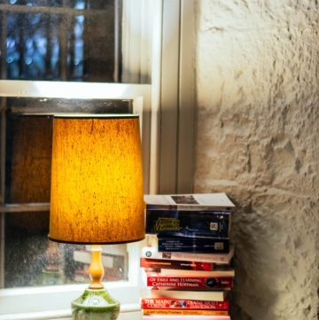 stack of books beside lamp