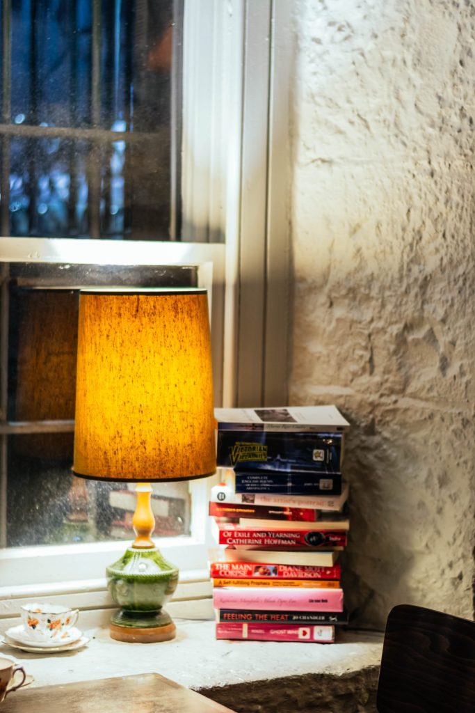 stack of books beside lamp