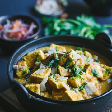 Indian cottage cheese curry in black bowl
