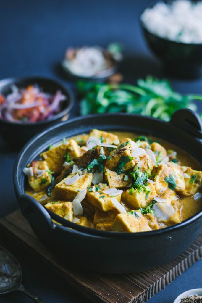 Indian cottage cheese curry in black bowl