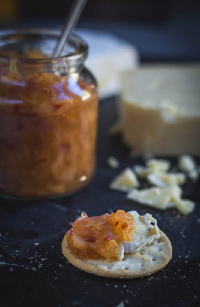 a dollop of apple, pear, chilli chutney along with cheese on a cracker