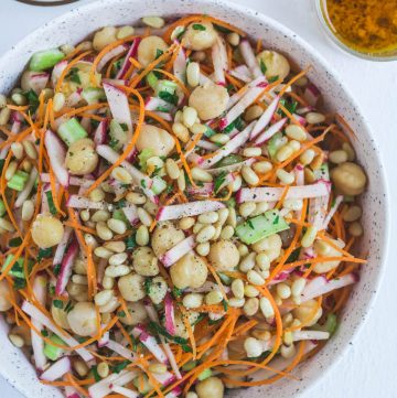 Chickpea, carrot, radish salad in white bowl