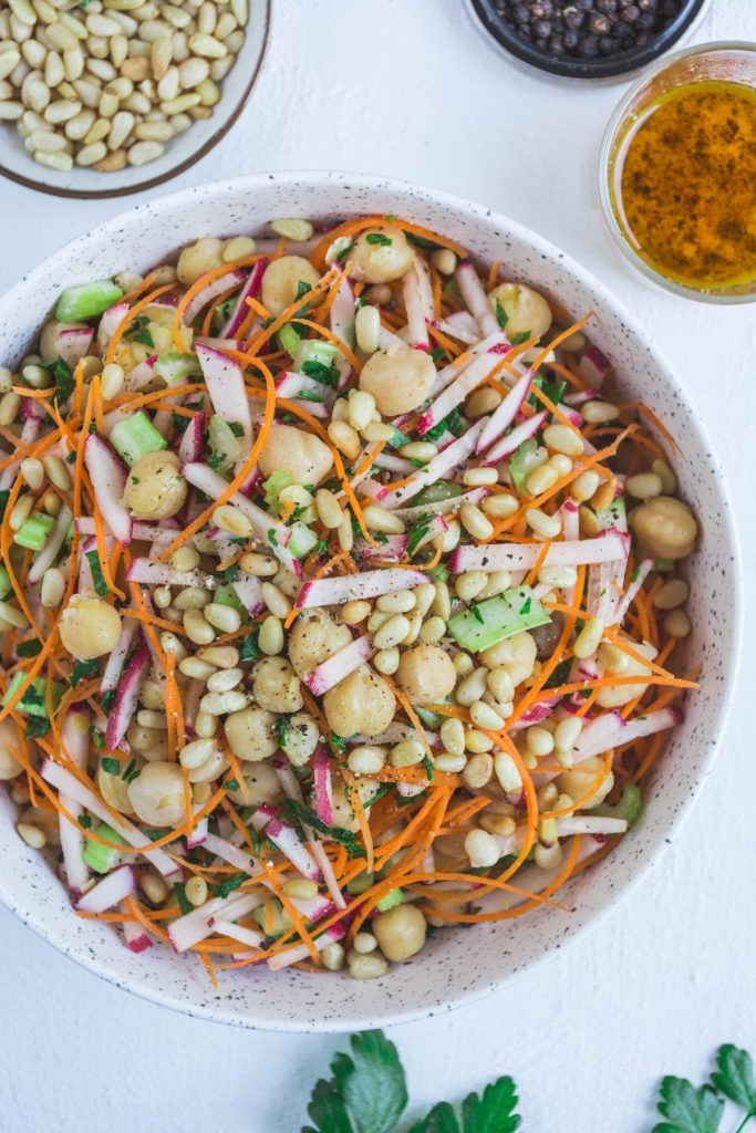 Chickpea, carrot, radish salad in white bowl