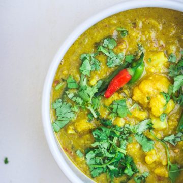 Indian cauliflower lentil curry in white bowl