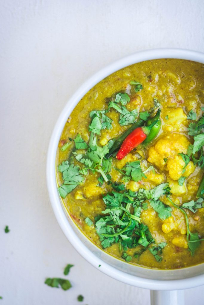 Indian cauliflower lentil curry in white bowl